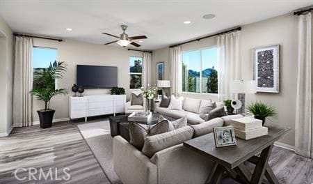 living room featuring ceiling fan, a wealth of natural light, and hardwood / wood-style flooring