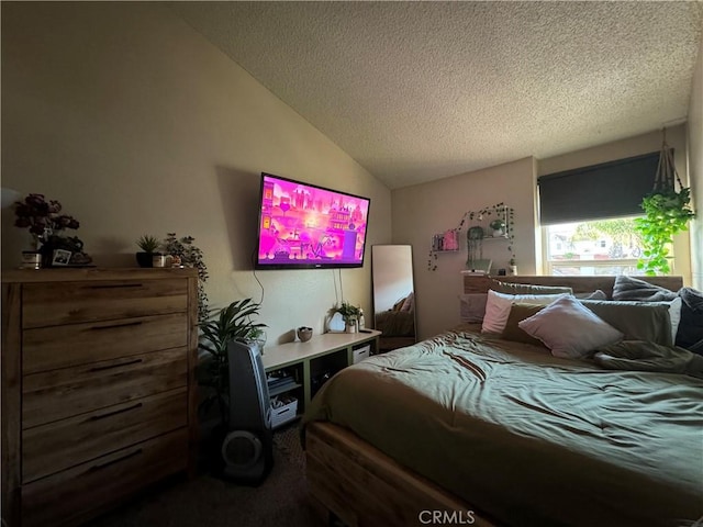 bedroom with lofted ceiling and a textured ceiling