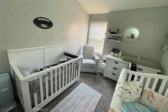 bedroom with a textured ceiling and a crib