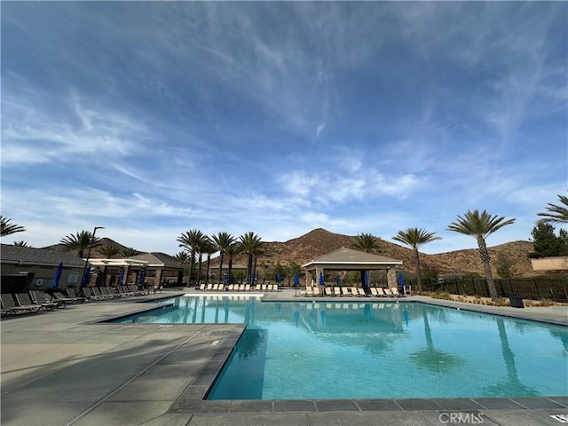 view of pool with a mountain view and a gazebo