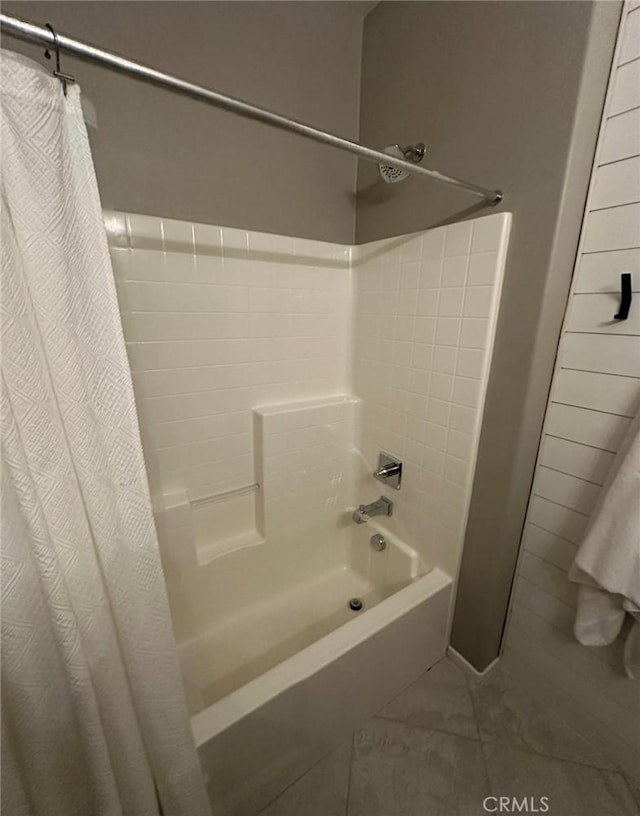 bathroom featuring tile patterned flooring and shower / bath combination with curtain