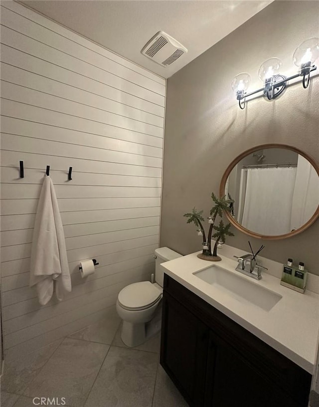 bathroom featuring tile patterned flooring, vanity, a shower with curtain, and toilet