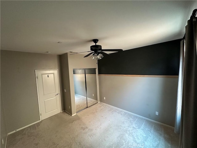 unfurnished bedroom with ceiling fan and carpet