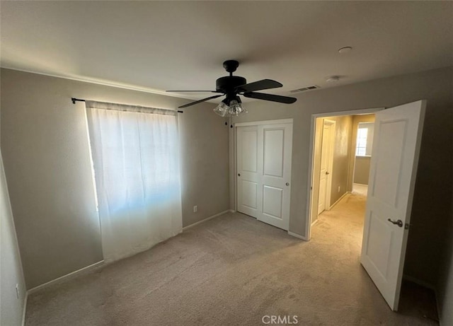 unfurnished bedroom with light carpet and ceiling fan