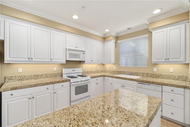 kitchen featuring white cabinets, white appliances, and sink