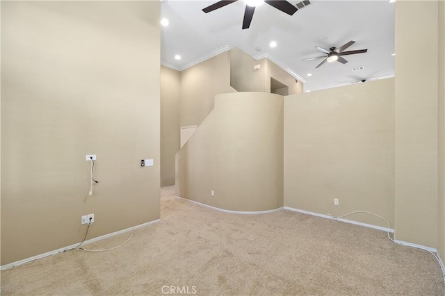 carpeted spare room with ceiling fan and crown molding