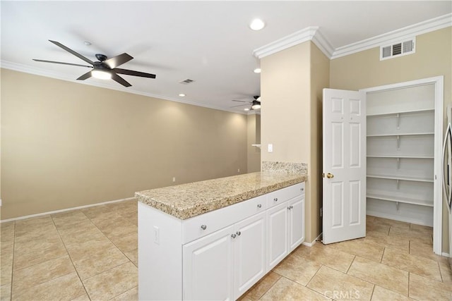 kitchen featuring ceiling fan, light stone counters, white cabinets, and ornamental molding