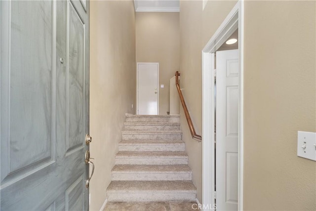 stairs featuring crown molding