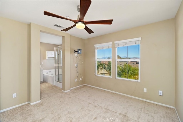 spare room with light carpet and ceiling fan