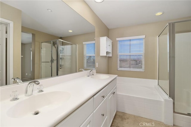 bathroom featuring vanity and independent shower and bath