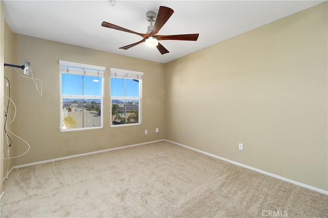 unfurnished room featuring light carpet and ceiling fan