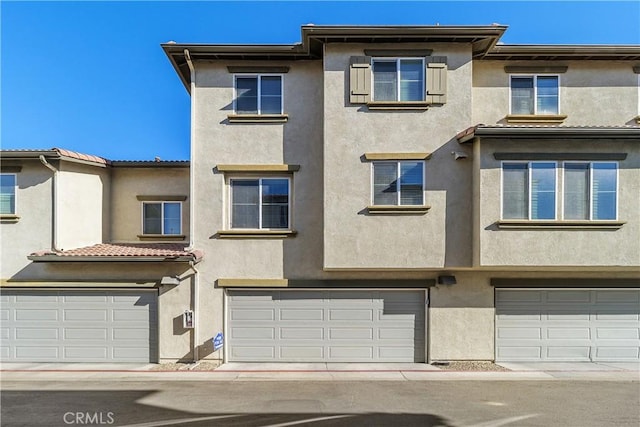 multi unit property featuring a garage