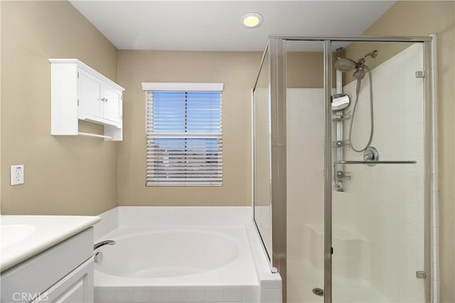 bathroom with vanity and independent shower and bath