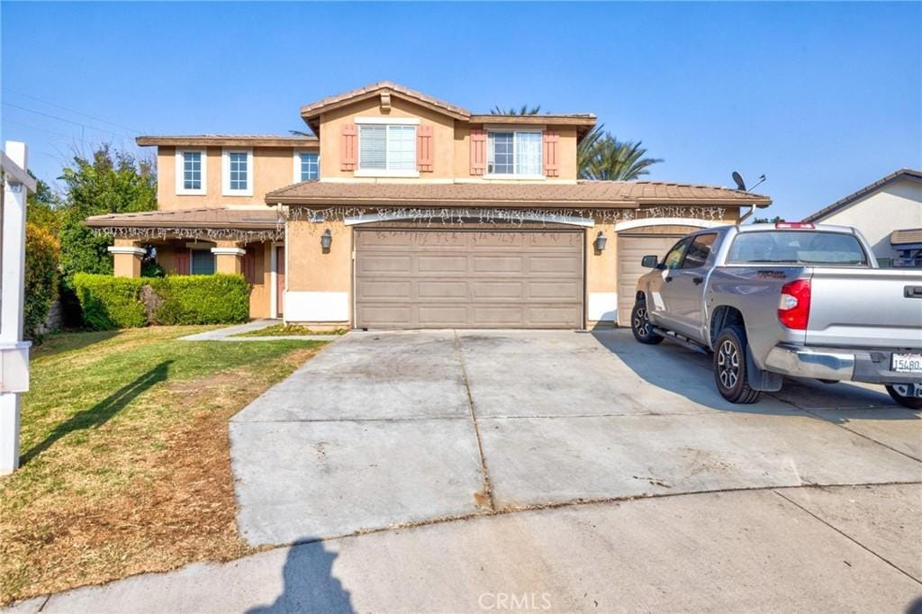 front of property with a garage and a front yard