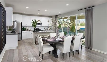 dining space with light wood-type flooring