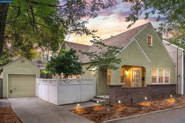 view of front of home featuring a garage, an outdoor structure, and a porch