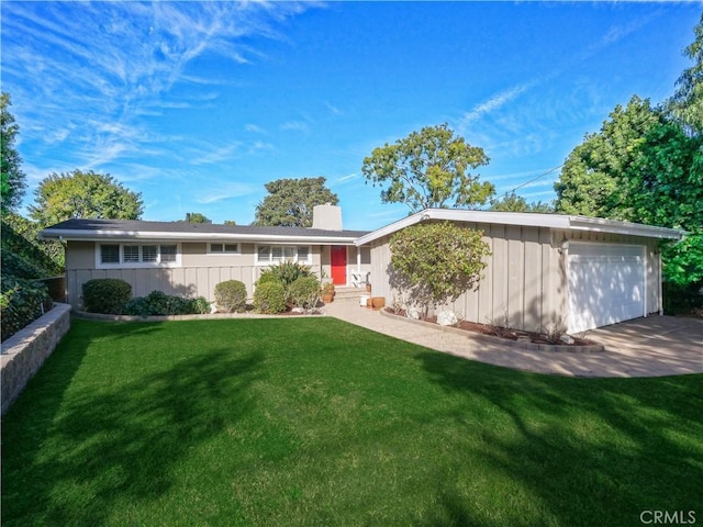 ranch-style home with a garage and a front yard