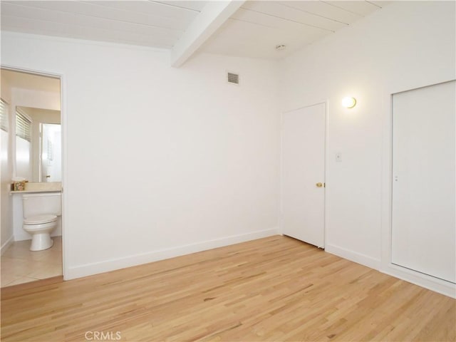 unfurnished room with wood ceiling, beamed ceiling, and hardwood / wood-style floors