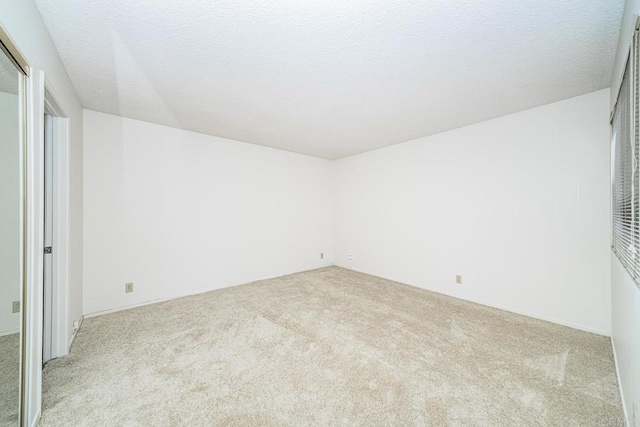 empty room featuring light carpet