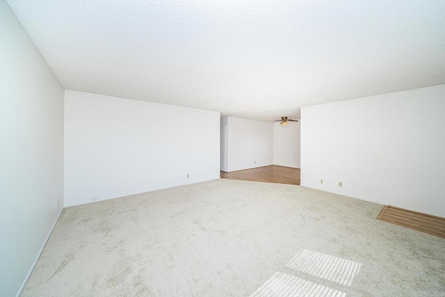 unfurnished room with ceiling fan and light colored carpet