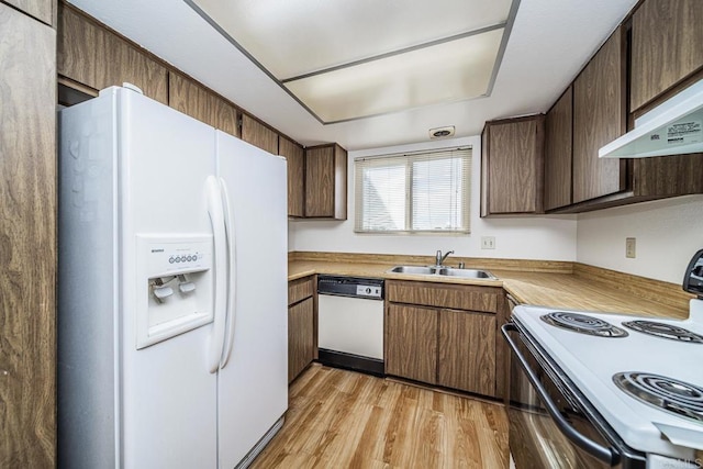 kitchen featuring extractor fan, sink, white appliances, and light hardwood / wood-style floors