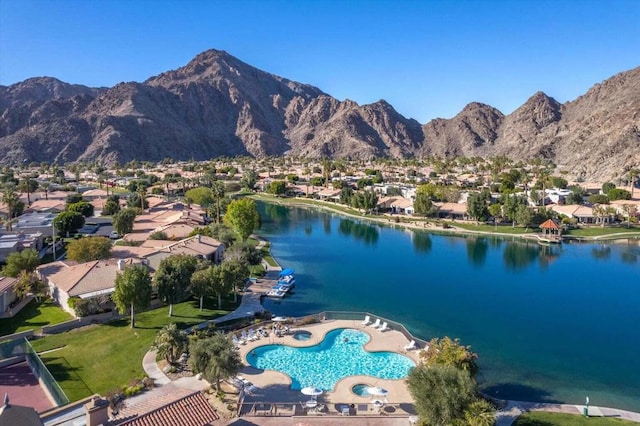 birds eye view of property featuring a water and mountain view