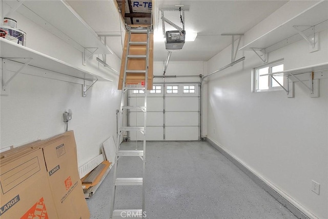 garage with baseboards and a garage door opener