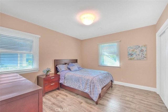 bedroom featuring light wood-style flooring and baseboards