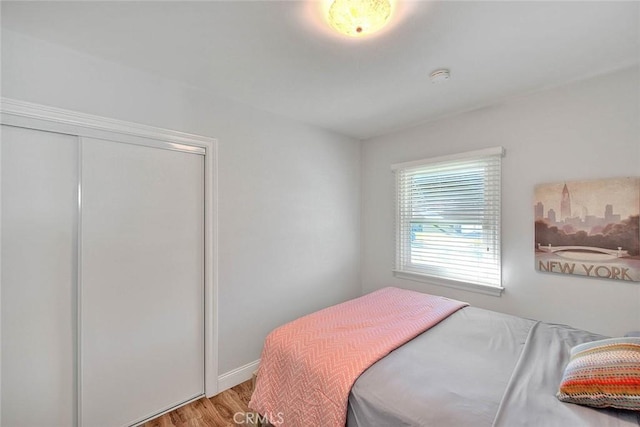 bedroom with a closet and wood finished floors