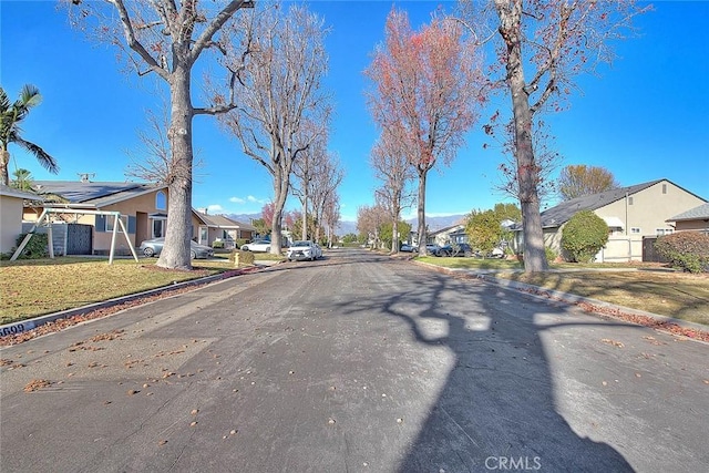 view of street with a residential view and curbs