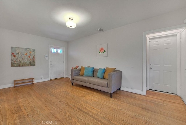 interior space with visible vents, light wood-style flooring, and baseboards