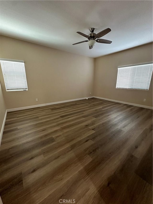 spare room featuring ceiling fan and dark hardwood / wood-style flooring