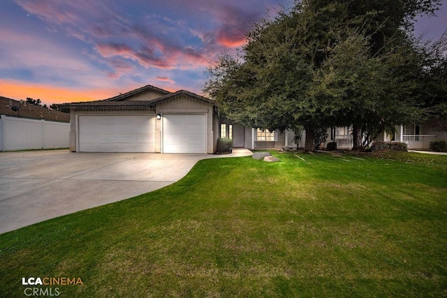 view of front facade with a garage and a yard