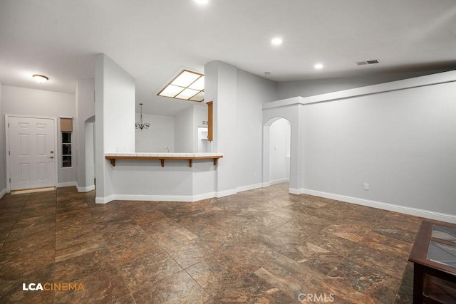 unfurnished living room featuring lofted ceiling