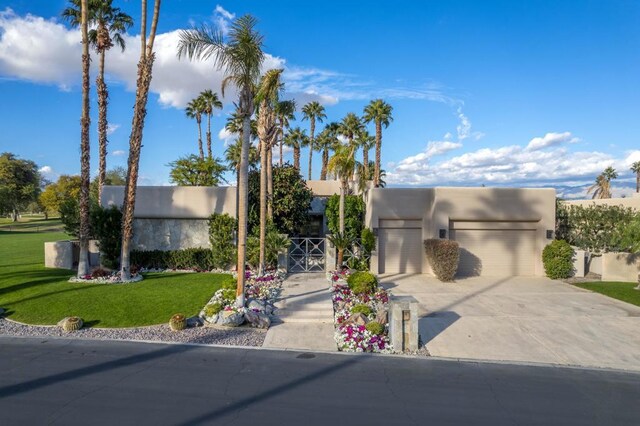 view of front of home featuring a front lawn and a garage