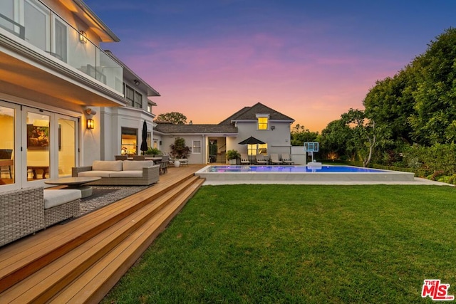 exterior space featuring an outdoor hangout area and a swimming pool side deck