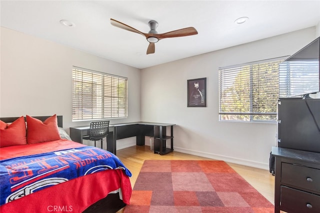 bedroom with ceiling fan and light hardwood / wood-style flooring