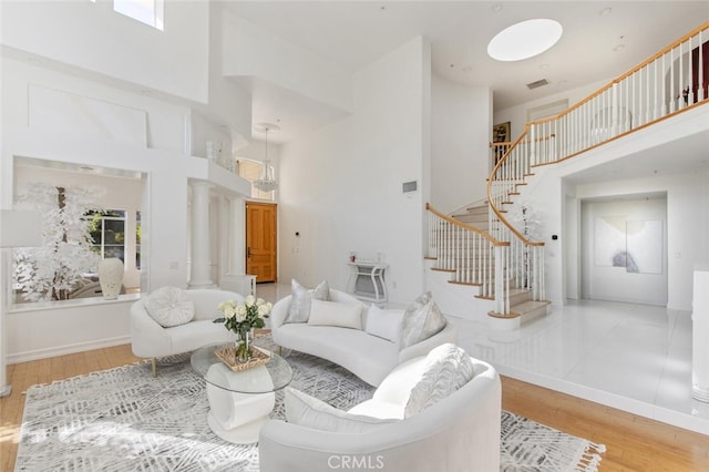 living room featuring hardwood / wood-style flooring and a high ceiling