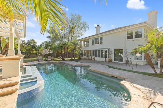 view of swimming pool with a hot tub and a patio