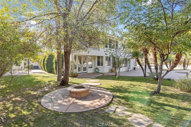 exterior space with a fire pit and a patio