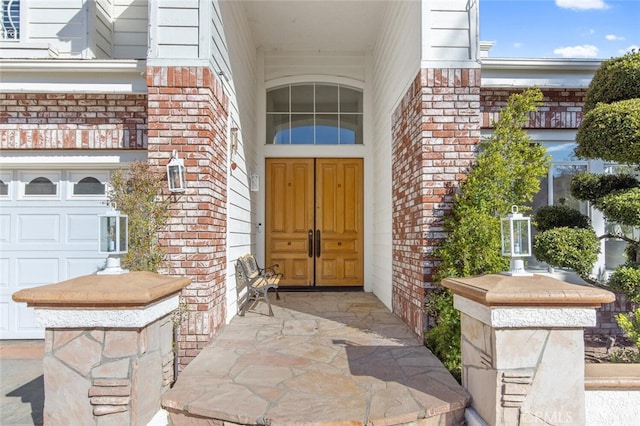 view of exterior entry featuring a garage