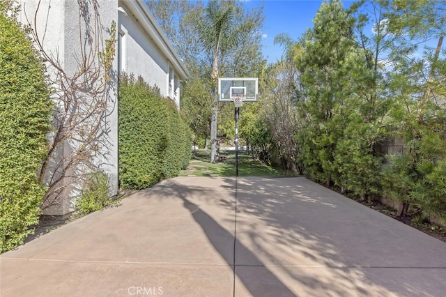 view of patio featuring basketball hoop