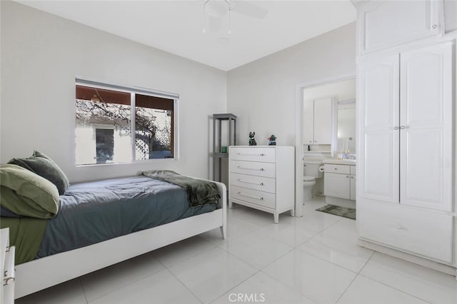 tiled bedroom featuring ceiling fan and connected bathroom