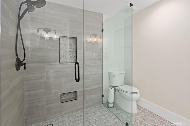 bathroom with toilet and a shower with shower door