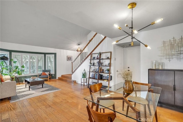 dining room with a notable chandelier and light hardwood / wood-style flooring