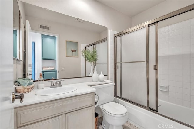 full bathroom featuring bath / shower combo with glass door, toilet, and vanity