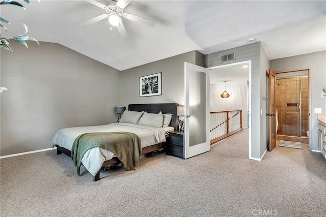 bedroom featuring ceiling fan, carpet floors, connected bathroom, and lofted ceiling