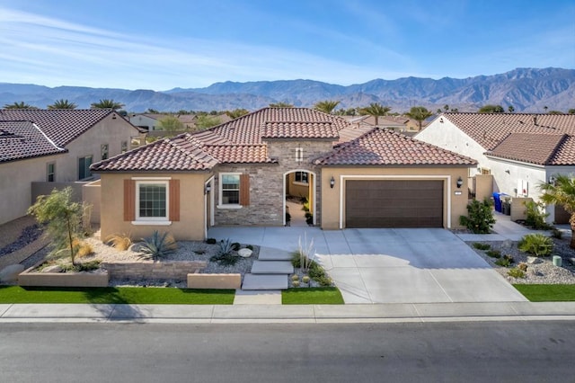 mediterranean / spanish house featuring a mountain view and a garage