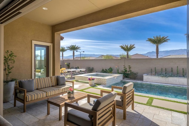 view of patio with a pool with hot tub, pool water feature, outdoor lounge area, and a mountain view