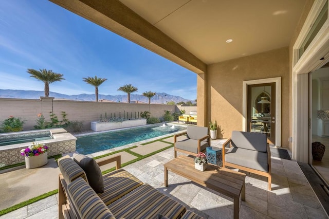 view of patio / terrace featuring a pool with hot tub, an outdoor hangout area, pool water feature, and a mountain view